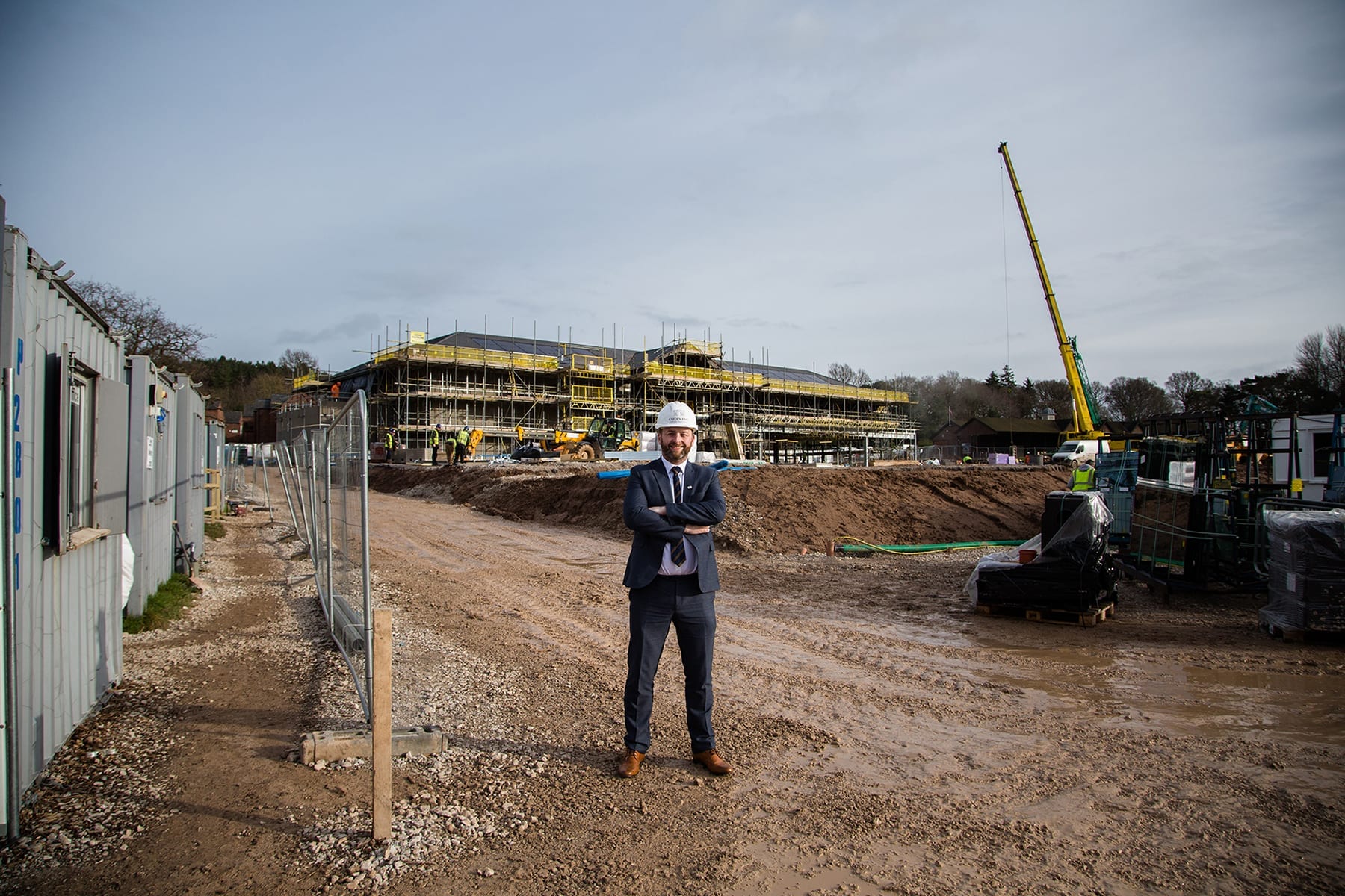 A man in a suit stood in a construction site