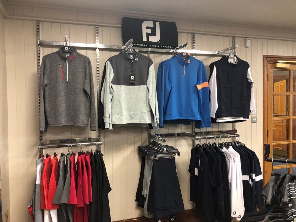 Golf half zips hanging up in the shop 