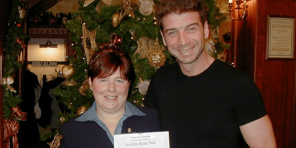 Nick Knowles with a woman getting an award