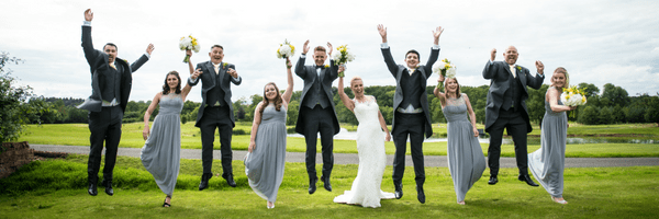 wedding guests jumping up in the air
