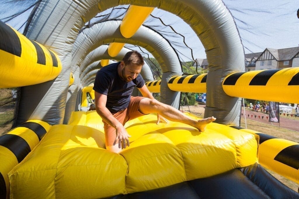 Someone doing an inflatable assault course