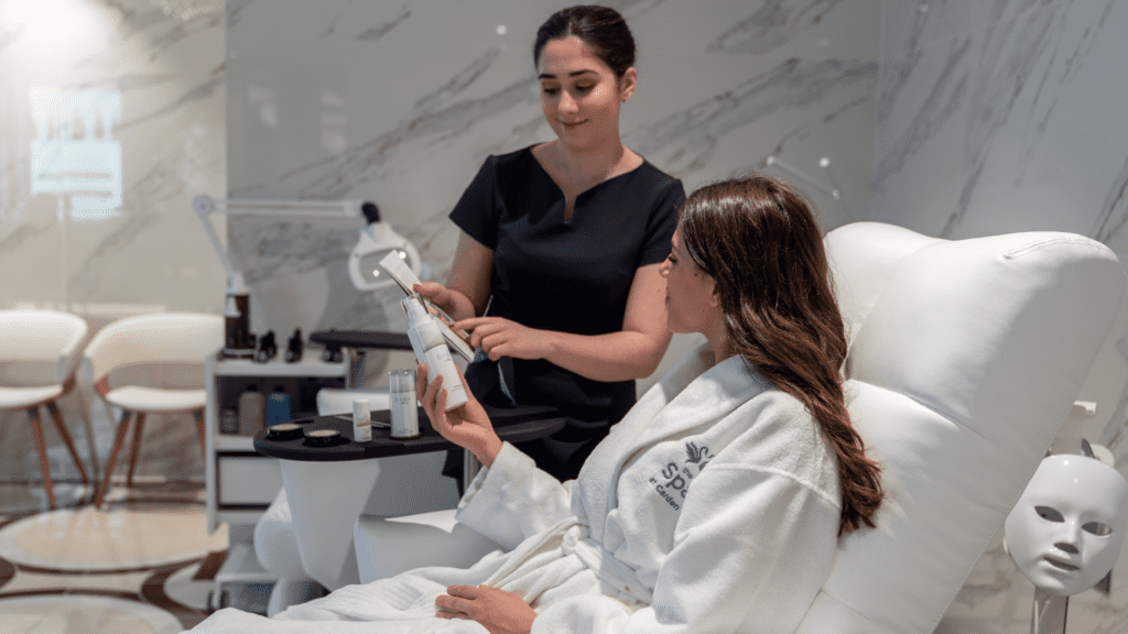 A spa therapist showing a customer different treatments for the spa
